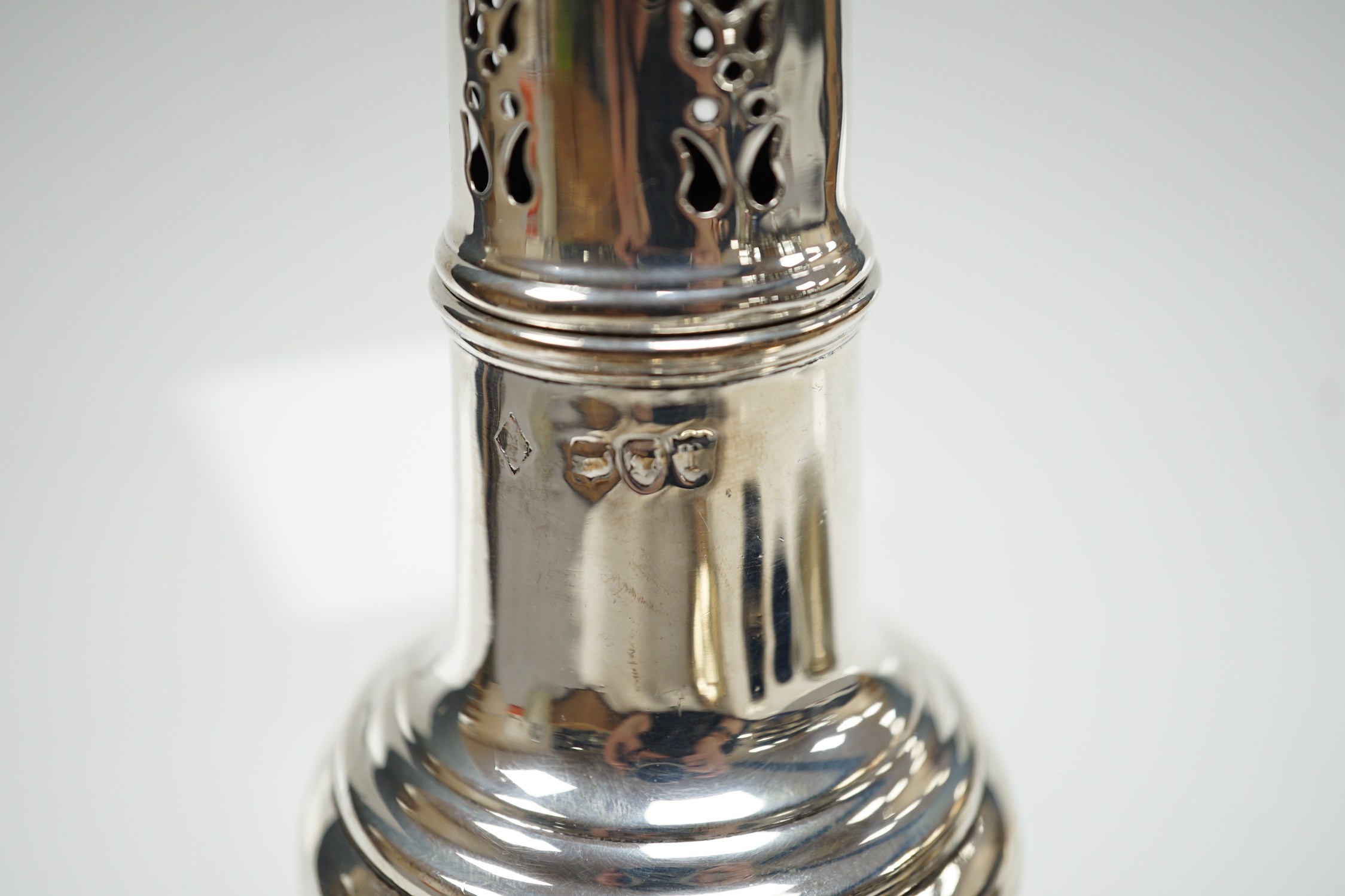 A mixed group of assorted small silver including a sugar caster, two pairs of Victorian bun salts, mustard pot, salt, pepperette, spoon and four white metal spoons.